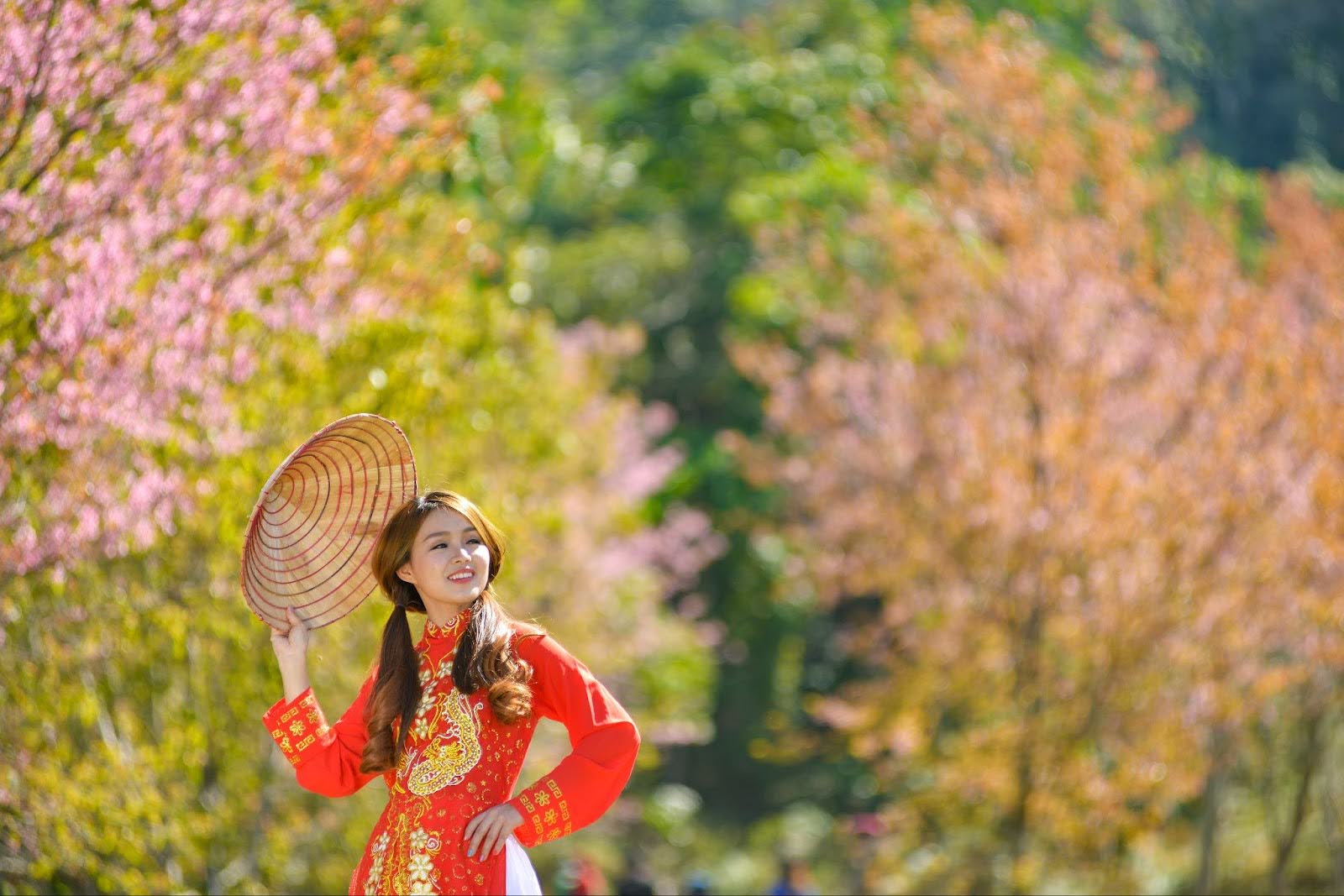 woman wearing red ao dai with gold embroidery