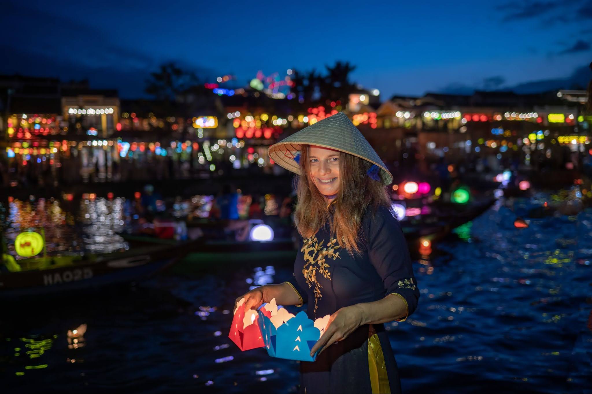 female tourist enjoying hoi an vietnam nightlife