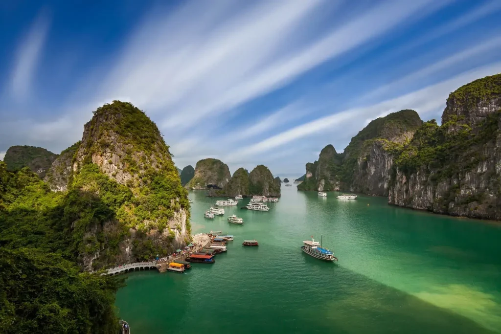 levated view of Hạ Long Bay, Vietnam, with towering vegetation-covered limestone karsts rising from emerald-green water