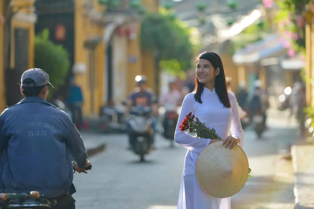 woman in vietnam traditional clothes holding flower